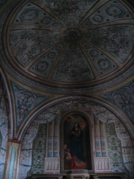 Frescoed dome with radiating coffers above an altar painting of the Virgin