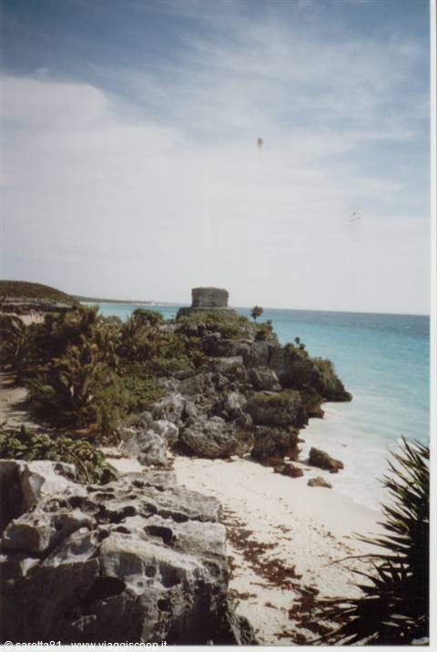 Mayan stone ruin on the cliff above Tulum's turquoise sea