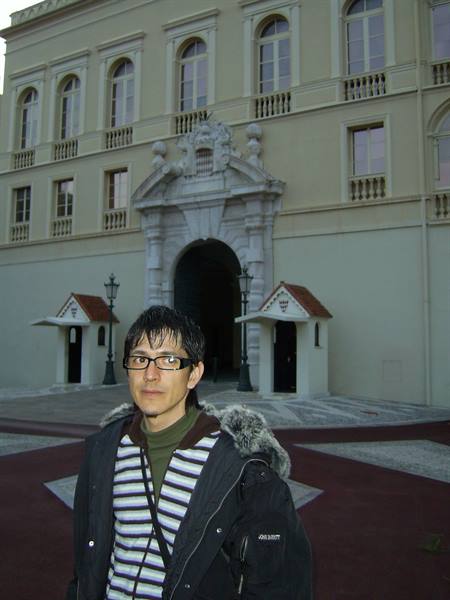 Tourist in front of the Prince's Palace of Monaco entrance with guard posts
