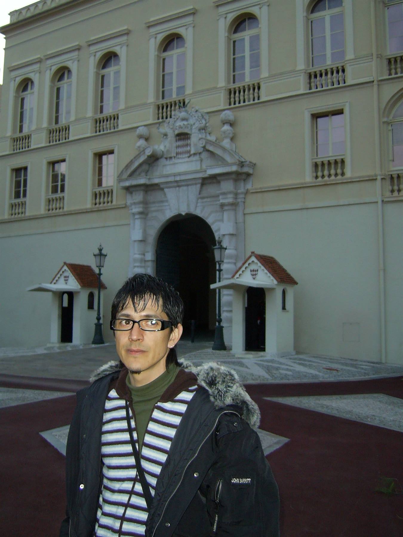 Tourist in front of the Prince's Palace of Monaco entrance with guard posts
