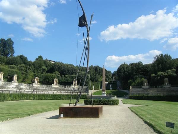 Metal sculpture in the Boboli Gardens amphitheater with statues and obelisk