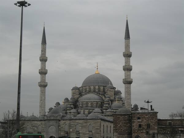 New Mosque in Istanbul with dome and minarets under grey sky