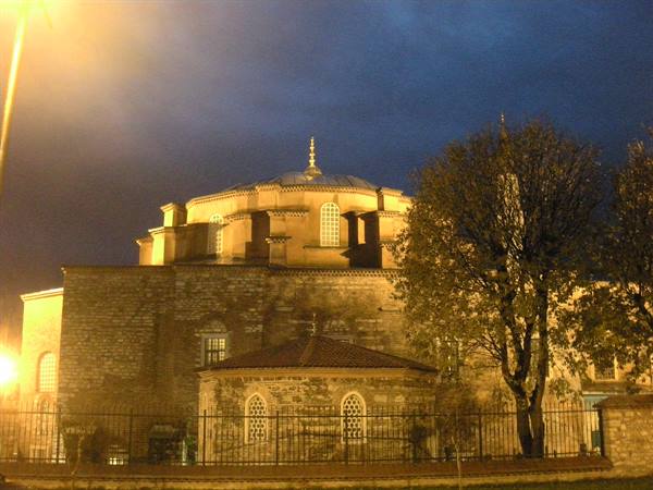 Hagia Irene church in Istanbul, illuminated dome at night among trees