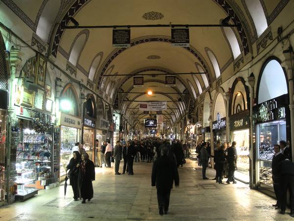 Shoppers browsing jewelry stalls under the painted vaults of Istanbul's Grand Bazaar