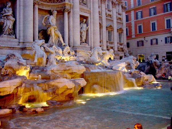 Trevi Fountain at night, illuminated statues and cascades into the basin