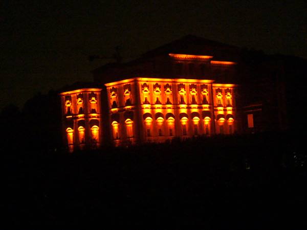 Historic palace lit with orange light in the dark night