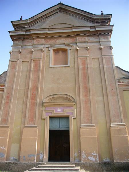 Ochre church facade with a half-open green door and stone steps