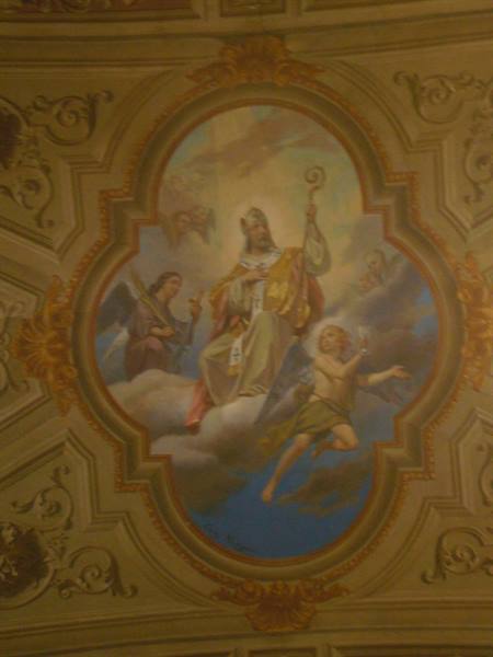 Ceiling fresco in a church: bishop in glory among angels and clouds