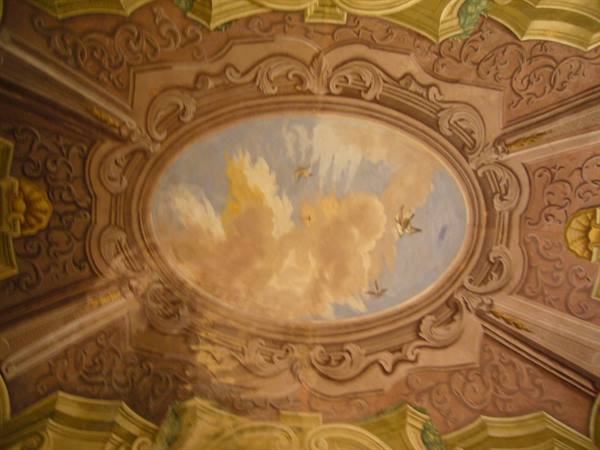 Baroque oval ceiling fresco with clouds and birds in stucco frame