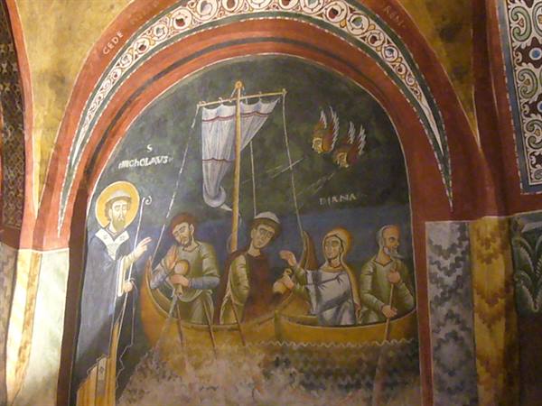 Medieval fresco of Saint Nicholas calming the storm inside an arched niche