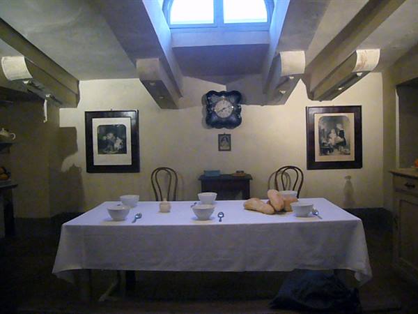 Set table with bread and bowls under a skylight window