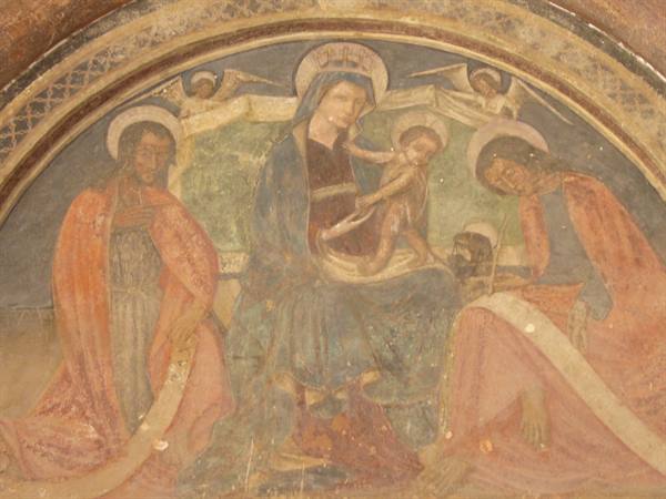 Medieval fresco of Madonna and Child with two kneeling saints