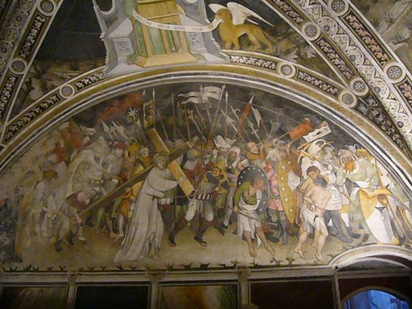 Medieval fresco of Christ carrying the cross among soldiers and banners