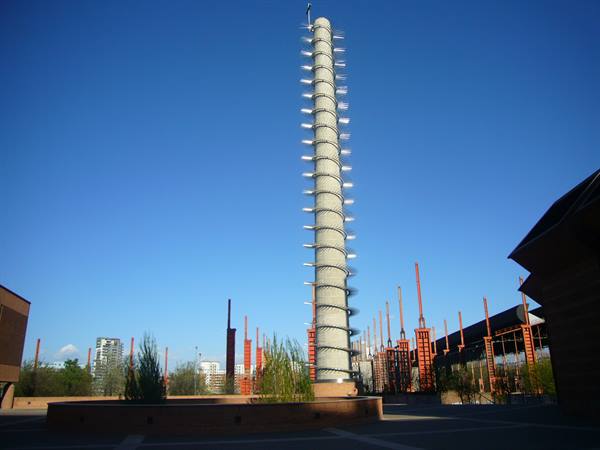 Parco Dora in Turin: spiral concrete tower among red steel industrial structures