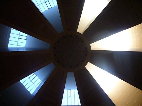 Wooden dome ceiling with radiating beams and bright windows