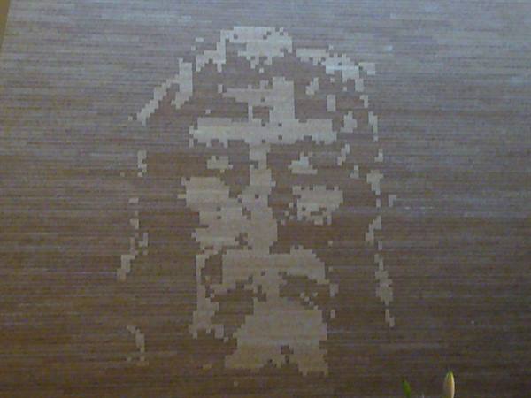 Face of Christ with cross made of light bricks on dark wall
