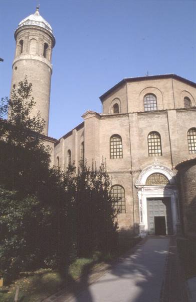 Basilica of San Vitale in Ravenna, ancient bricks and cylindrical bell tower under blue sky