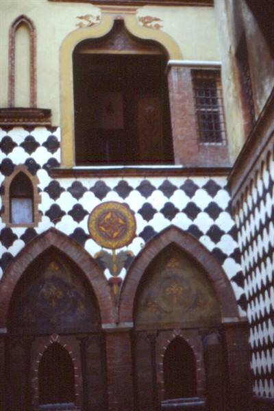 Brick pointed arches with black and white diamond-patterned decorations