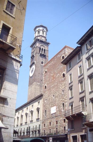 Brick Lamberti Tower rising over Piazza delle Erbe, Verona, blue sky