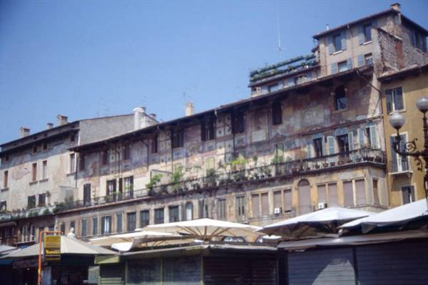 Faded frescoed facades above market umbrellas, Piazza delle Erbe in Verona
