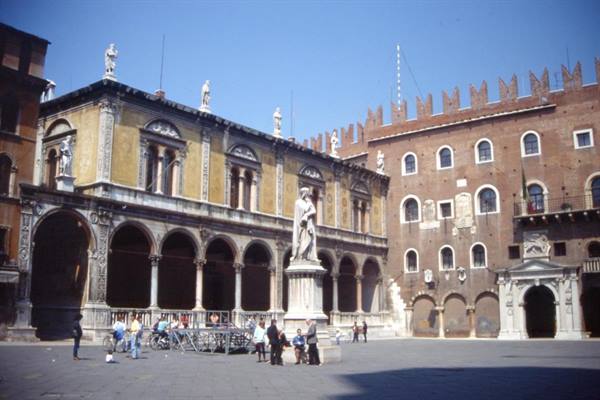 Dante statue in Piazza dei Signori, Verona, with loggia and brick palaces