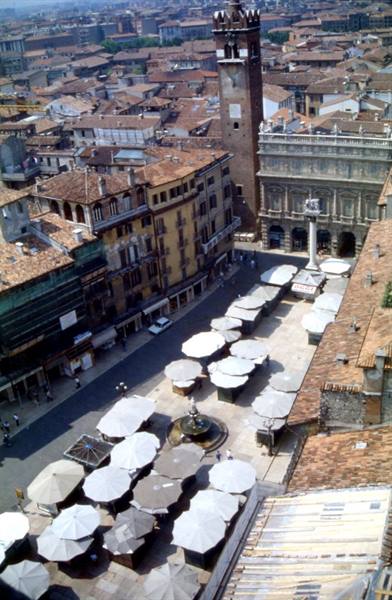Piazza delle Erbe in Verona with closed market umbrellas, fountain and Lamberti Tower