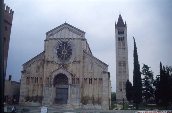 San Zeno Basilica in Verona, Romanesque facade with rose window and bell tower under gray sky