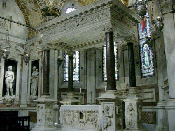 Carved marble canopy over Saint Dominic's ark, dark columns, stained glass windows