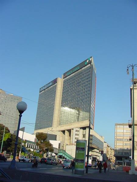 Campania skyscraper towering over traffic at Naples' Piazza Garibaldi