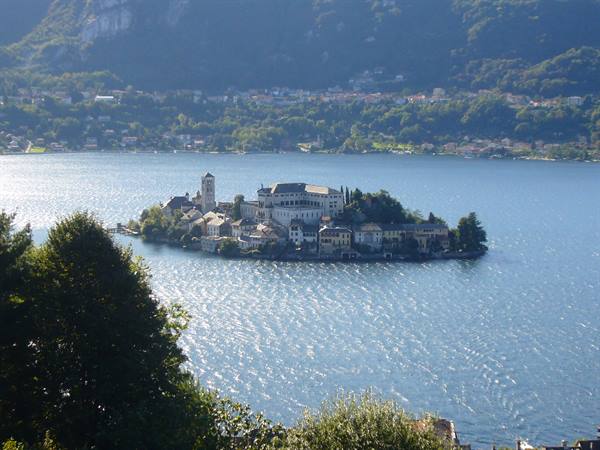 San Giulio Island with basilica and houses surrounded by Lake Orta