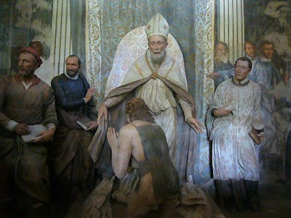 Fresco of a bishop in cope welcoming a kneeling man, surrounded by onlookers