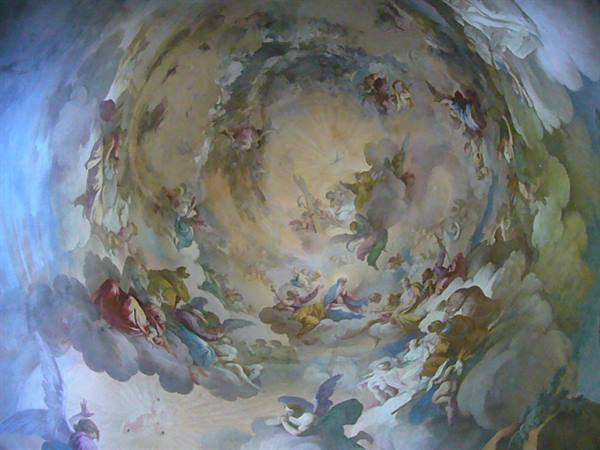 Baroque fresco with angels and clouds painted on a church ceiling