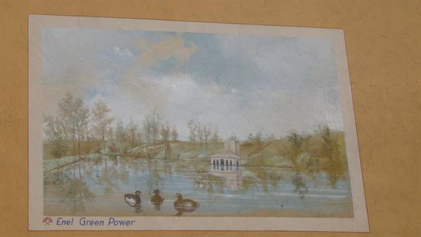 Wall painting of pond with ducks and white building, Enel Green Power sign