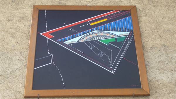 Abstract geometric painting in wooden frame hanging on a wall
