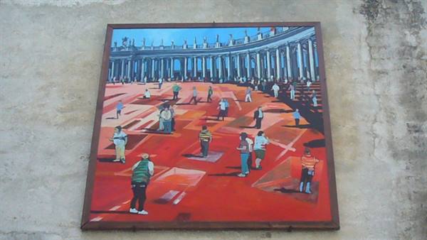 Painting of St. Peter's Square hung on a plastered wall