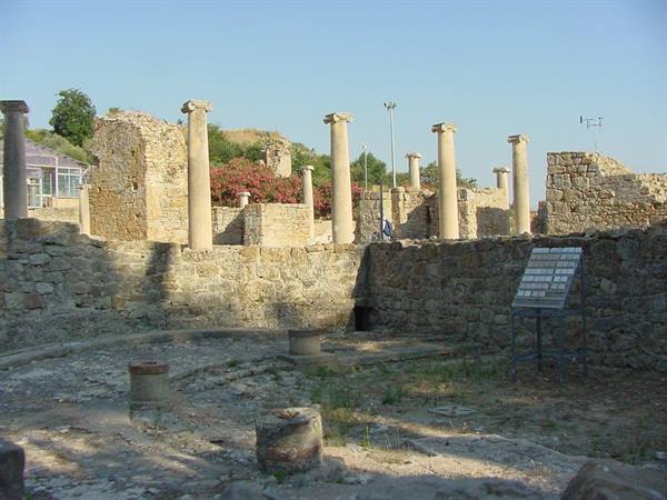 Ancient stone columns and ruins under a clear blue sky