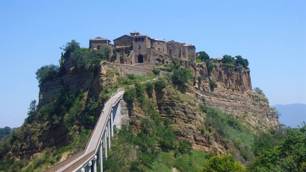 Civita di Bagnoregio, footbridge leading to the tuff hilltop village under sun