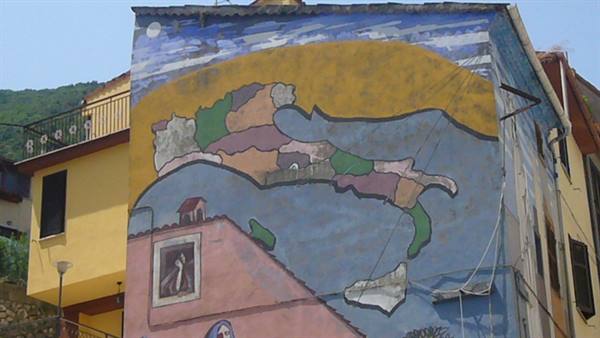 Painted mural on house facade, colorful map over yellow and blue background