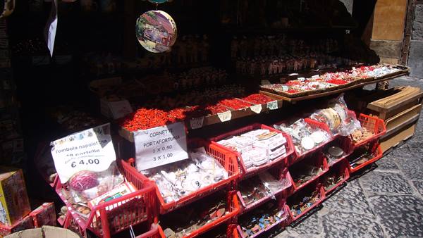 Souvenir stall with confetti and novelties in red crates on cobblestones