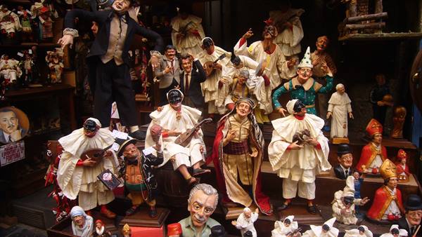Pulcinella and nativity figurines displayed in a San Gregorio Armeno workshop, Naples