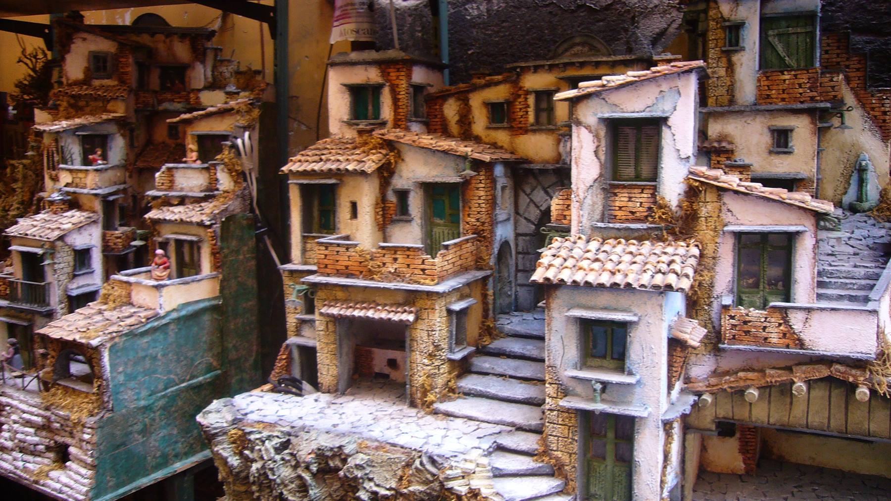 Presepe in miniatura con case di carta e legno, tetti di terracotta, scale e vicoli