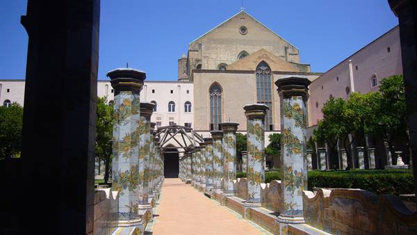 Majolica-decorated columns in Santa Chiara cloister, Naples, in bright sunlight