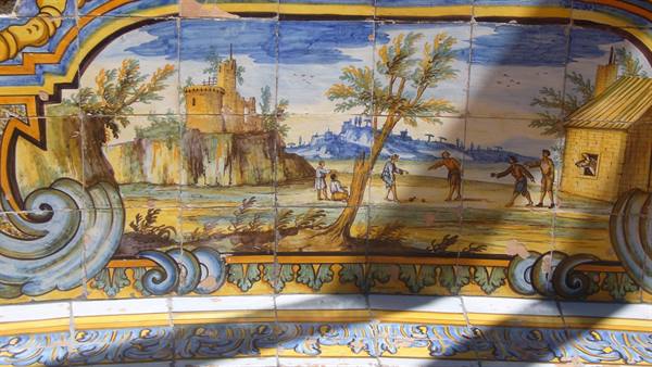 Painted majolica tile panel with rural scenes, castle and cottage, natural light