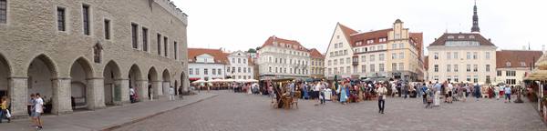Tourists and market stalls in the medieval square beside Tallinn's old town hall