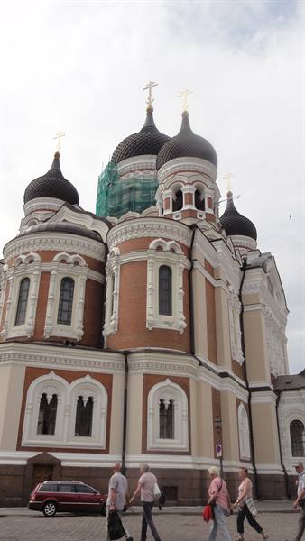 Alexander Nevsky Cathedral in Tallinn, black Orthodox domes, pedestrians passing by