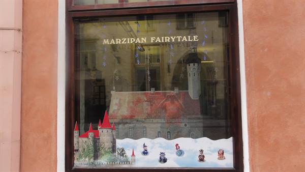 "Marzipan Fairytale" shop window with marzipan castle, town hall tower reflected