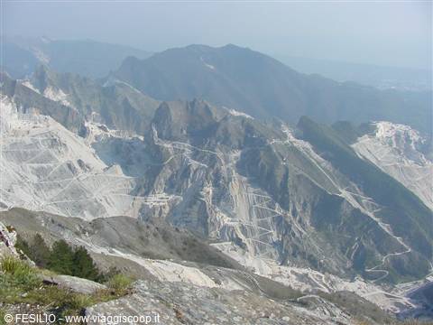 Marble quarries in the Apuan Alps, white carved cliffs among rocky mountains