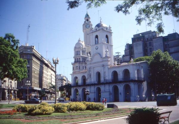 Buenos Aires' white colonial Cabildo among flowerbeds and city buildings