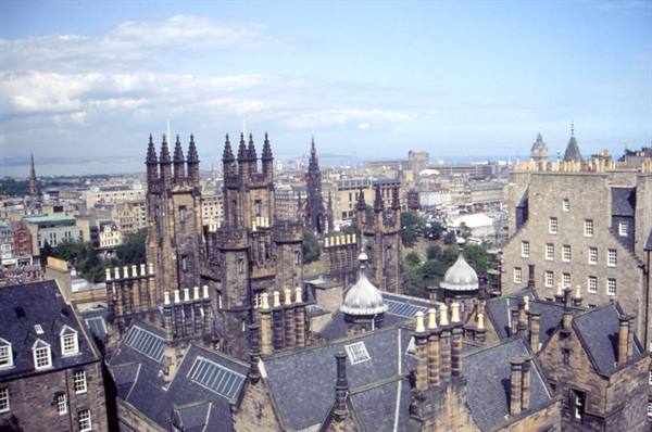 Gothic spires and slate rooftops of Edinburgh under a cloudy sky
