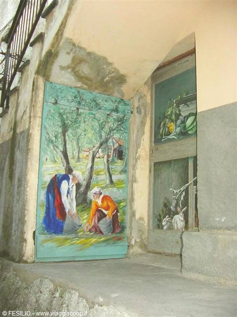 Wooden door painted with peasant women and rabbits, under an arch
